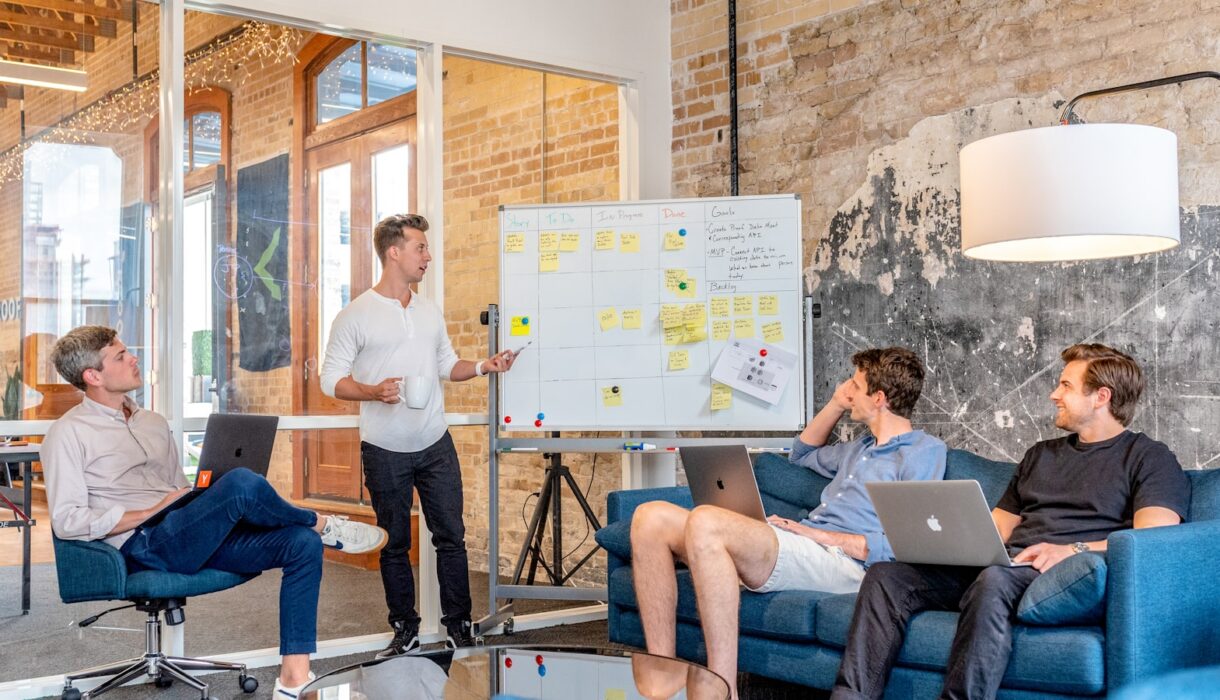 A team working through a problem at a whiteboard
