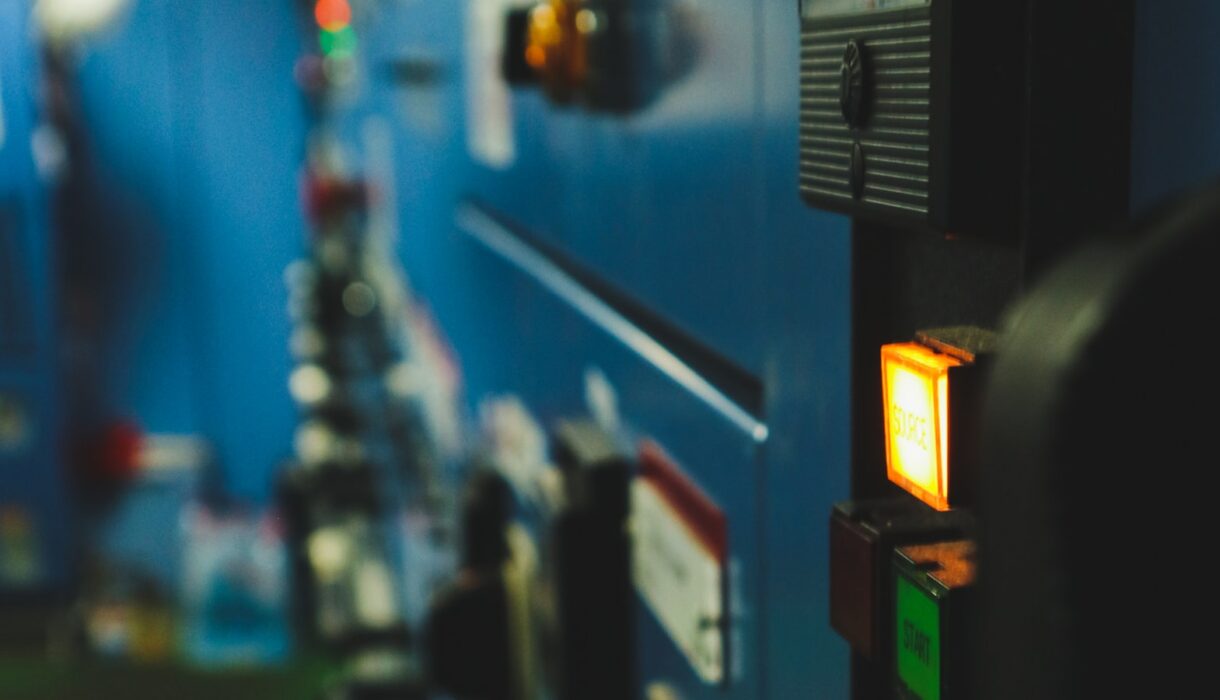 A wall of indicator lights in a darkened room