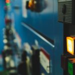 A wall of indicator lights in a darkened room